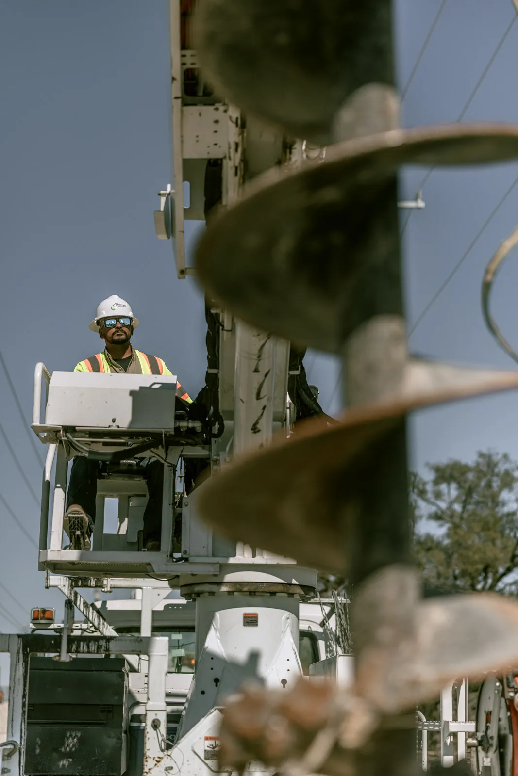 Greenstone Electrical Services crew member carrying conduit